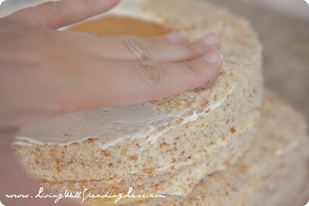 Layer the round cakes and cover them with the frosting and graham cracker sand.