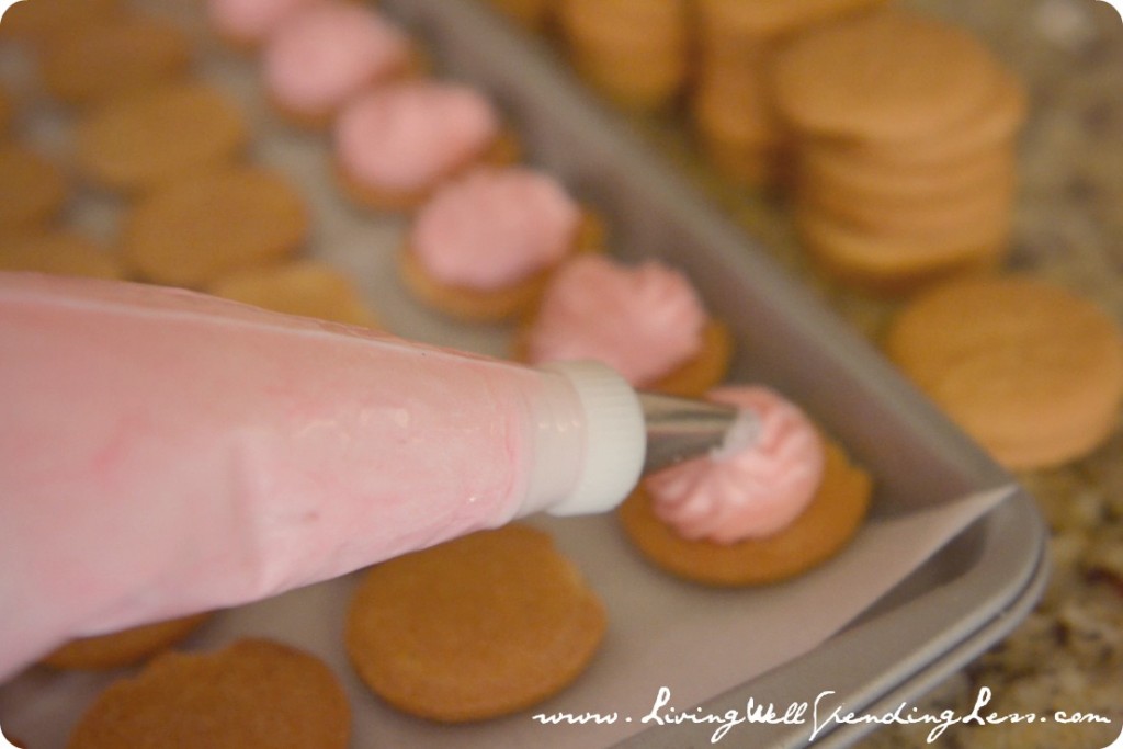 Pipe a dollop of frosting on each wafer for the bottom of your oyster cookie. 