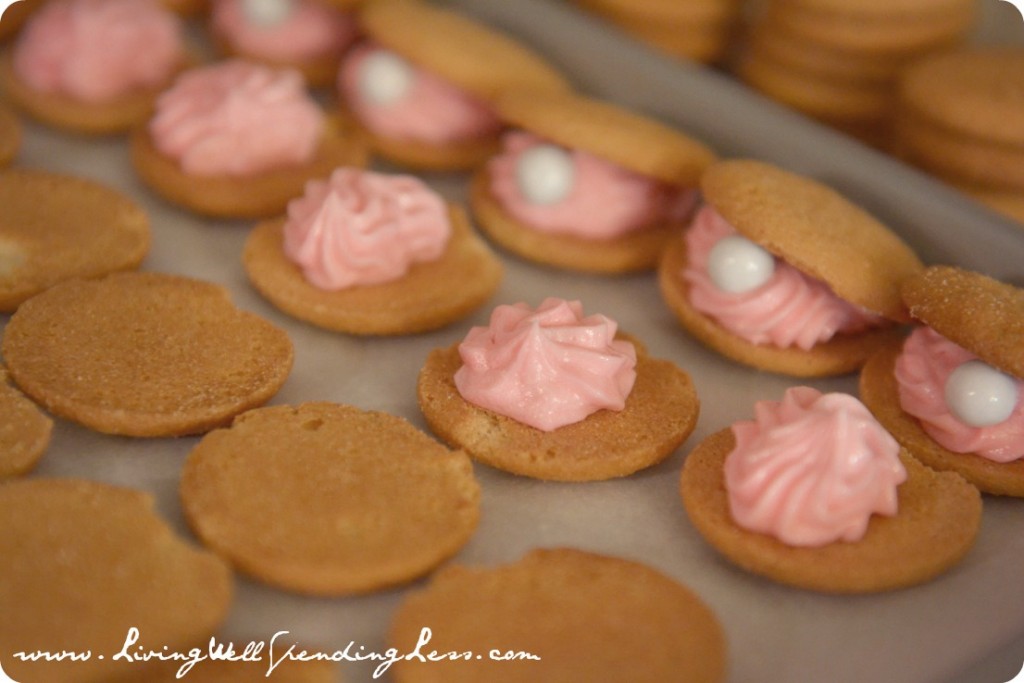 Top each oyster bottom with a second cookie and add a "pearl" candy to each. 