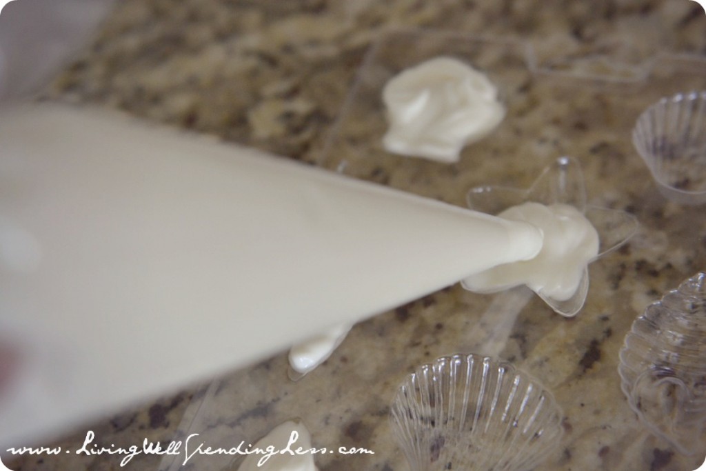 Pipe melted white chocolate into seashell molds to decorate your sand castle cake. 