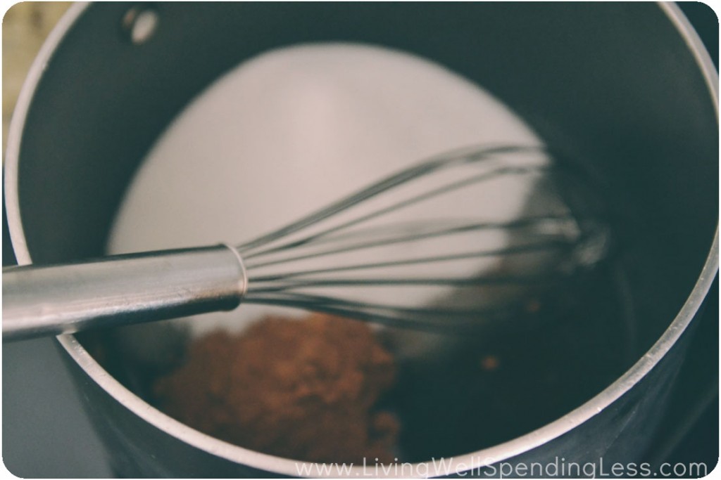 Whisk together cocoa powder, sugar, and coconut oil in a large saucepan. 