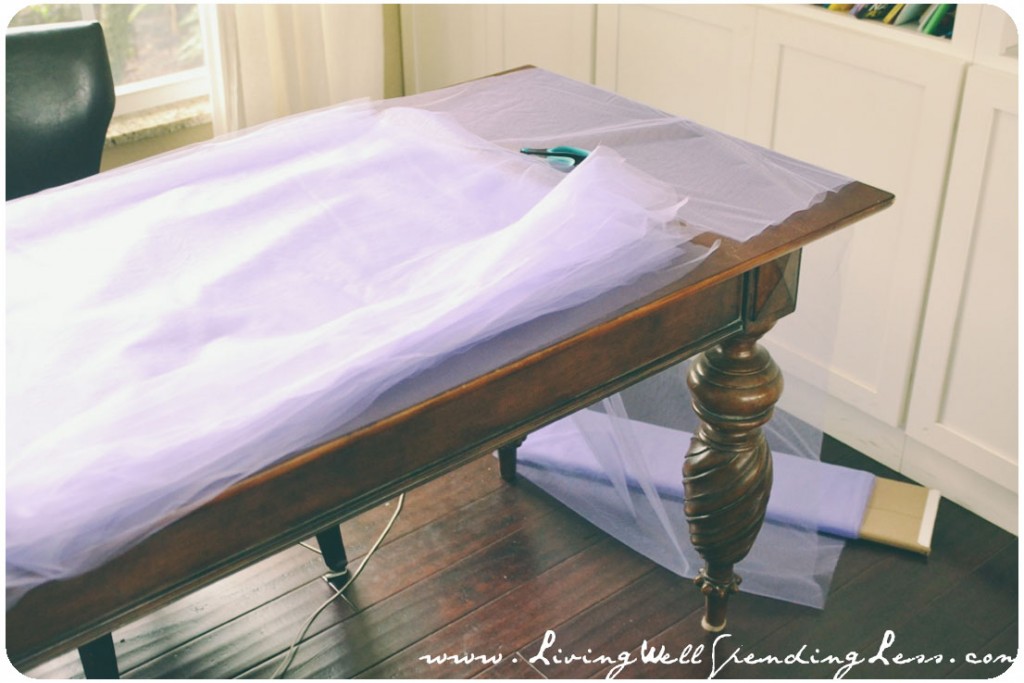 When you cut tulle, it helps to lay it flat on a table. 