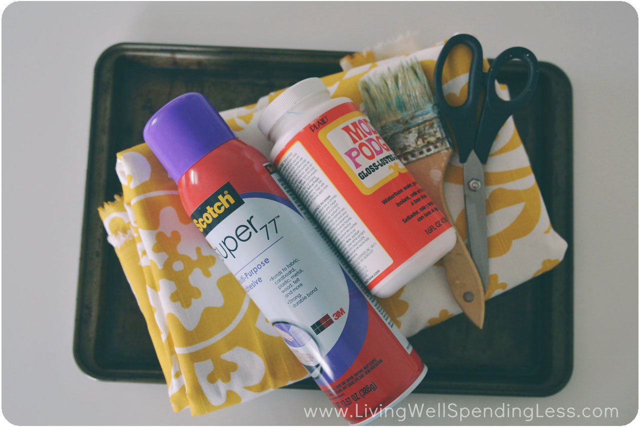 Assemble your materials: Old cookie sheet, fabric, spray adhesive, Mod Podge, paint brush, and scissors/pinking shears. 