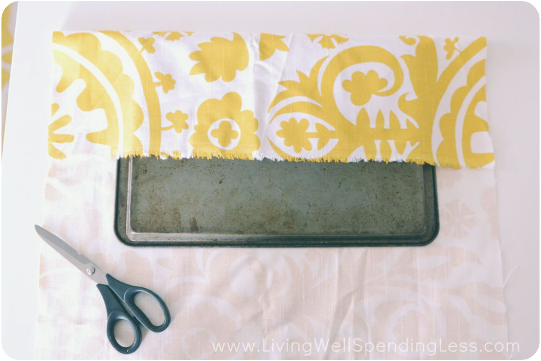 Cut a piece of fabric to wrap around cookie sheet. 