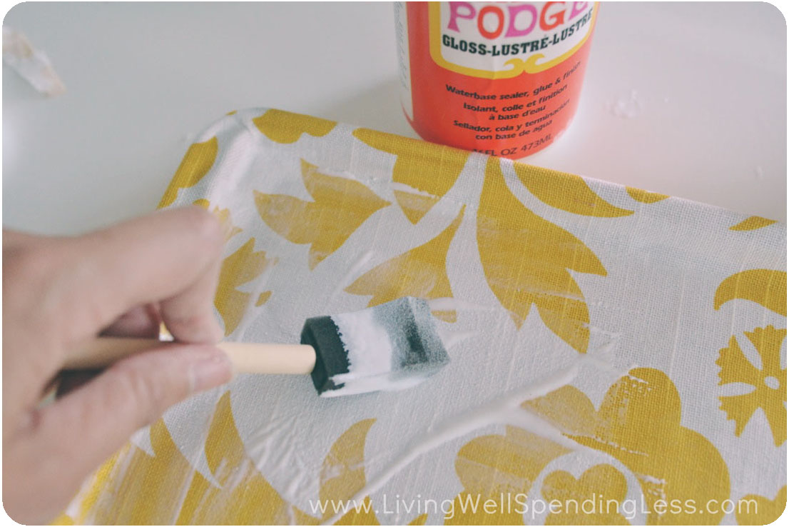 Use a paint brush to coat the top and inner sides of the tray with Mod Podge. 