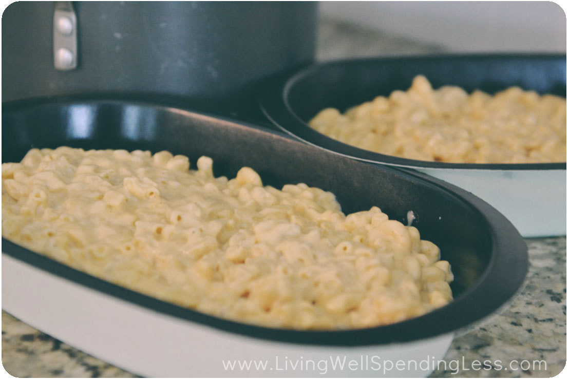 Divide macaroni and cheese into casserole dishes. You can wrap these with plastic wrap and bake later for an easy freezer meal. 