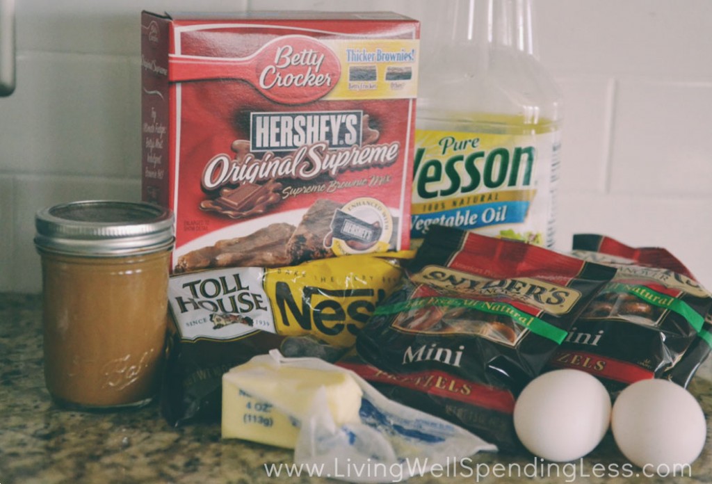 Assemble the ingredients for these delicious salted caramel pretzel brownies: brownies, pretzels, eggs, butter, chocolate chips and caramel. 