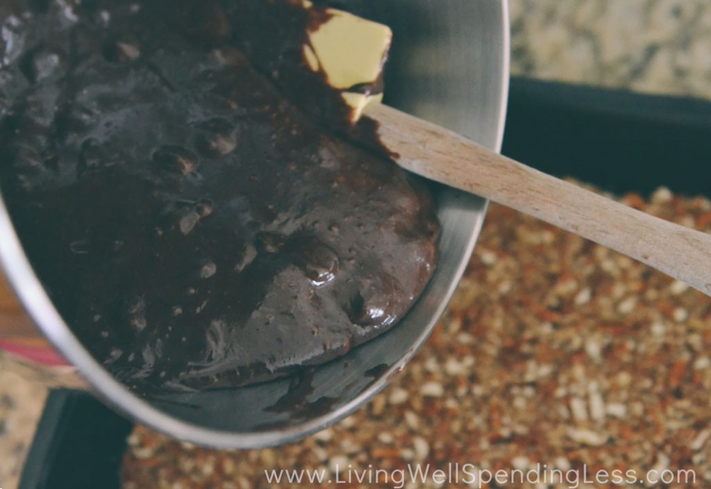 Pour the brownie batter over the crushed pretzels in the pan. 