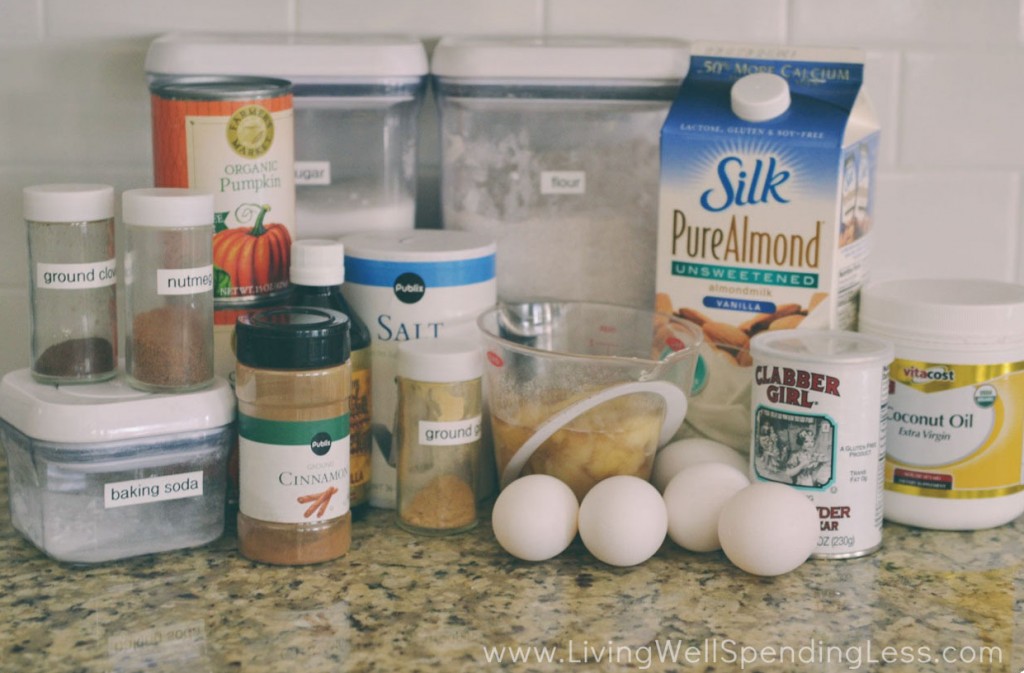 Assemble your ingredients for the skinny pumpkin bread: Whole wheat flour, baking soda, baking powder, salt, cinnamon, nutmeg, ground ginger, ground cloves, eggs, sugar, ripe bananas mashed, vanilla, coconut oil, unsweetened almond milk and pureed pumpkin. 