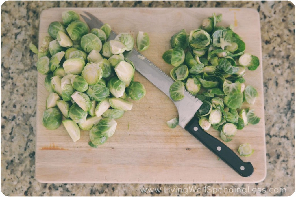 Chop Brussels sprouts on a cutting board with a knife. 