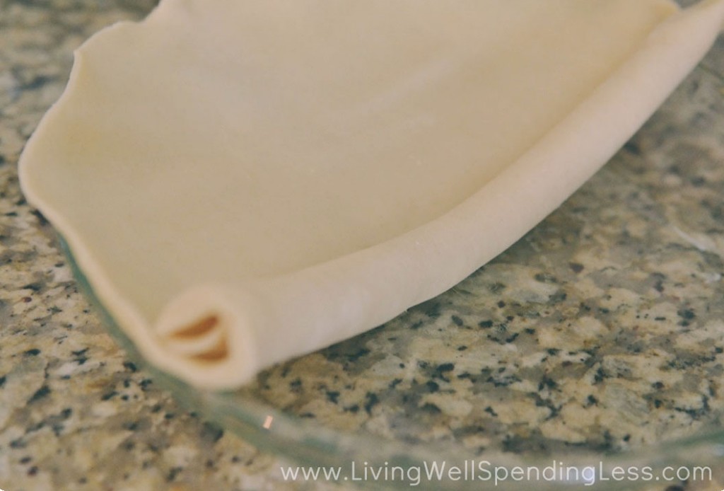 Unroll the packaged pie crust into a clear glass pie pan. 