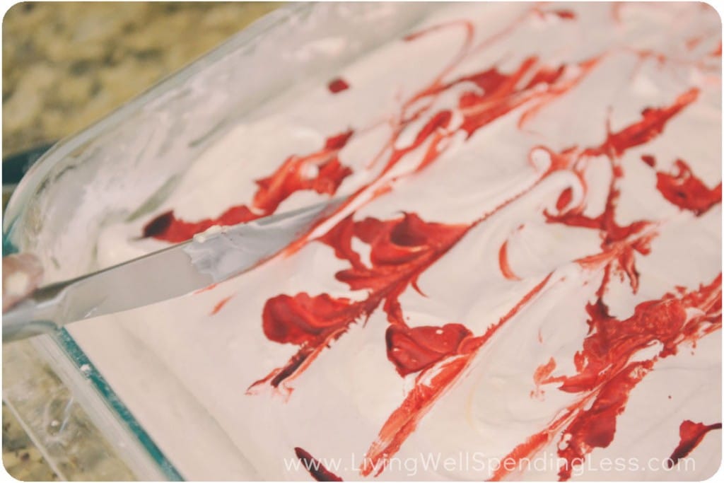 Add in red food coloring to the marshmallow mixture. 