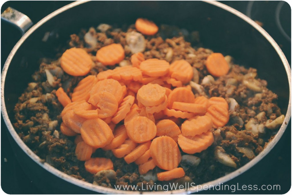 Add carrots to vegetarian crumbles mixture in pan. 