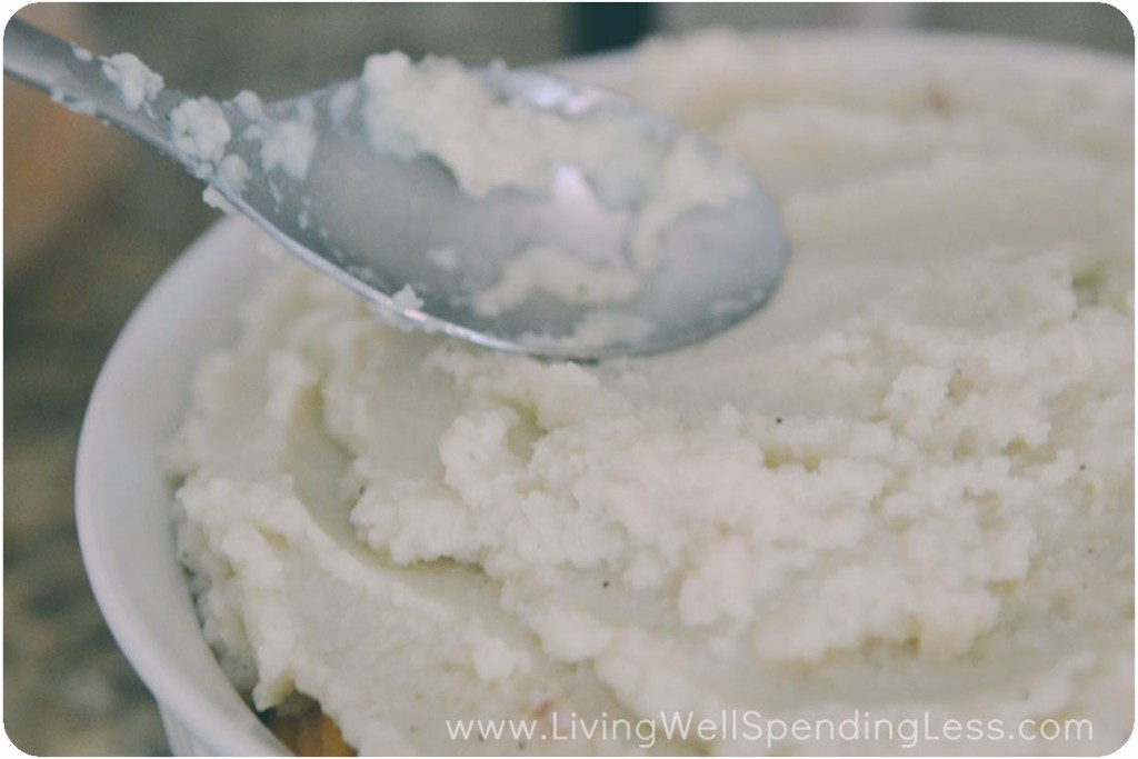 Spoon mashed potatoes or mashed cauliflower over top of mixture. 