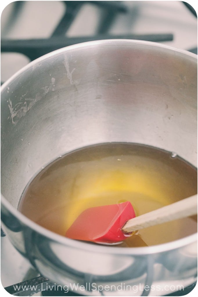 Melt beeswax and coconut oil in a small pot and mix with a rubber spatula. 