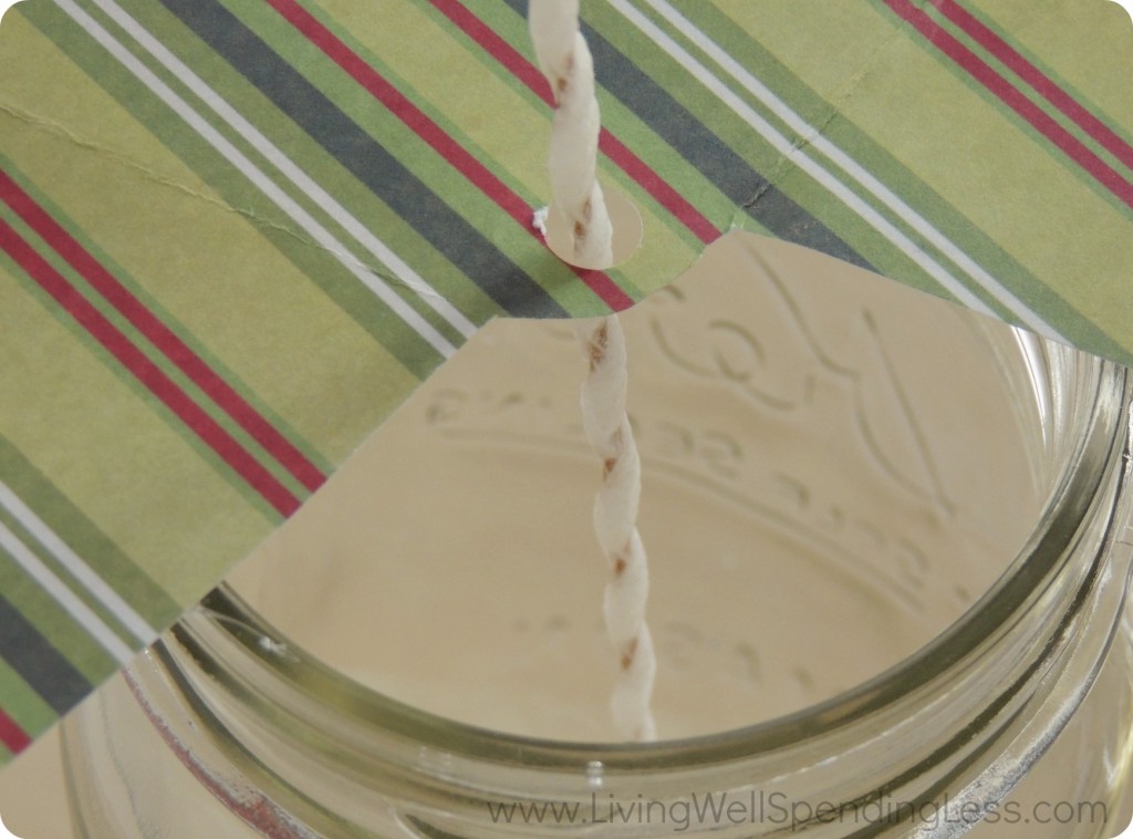 A piece of cardstock with a hole punched in it makes a great holder to keep your wick upright when you add the wax to your candle. 