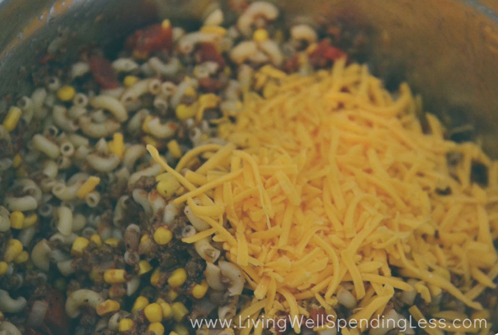 Add macaroni and shredded cheese to the goulash. 