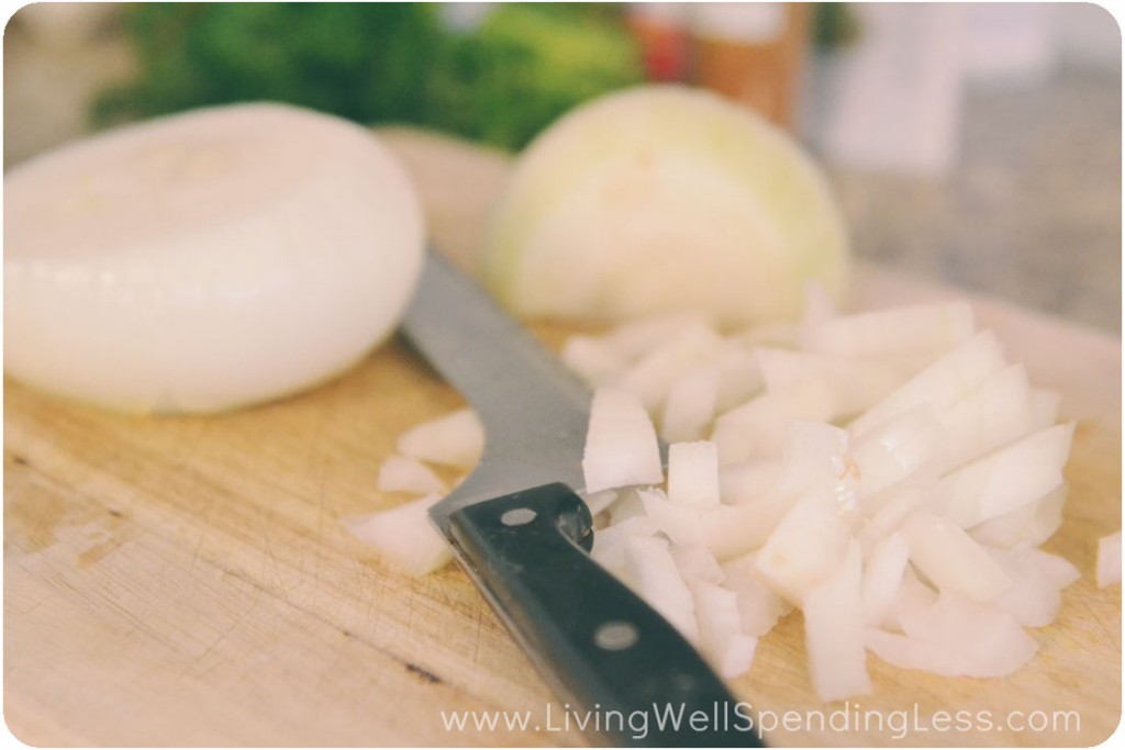 Chop onions for the creamy potato soup.