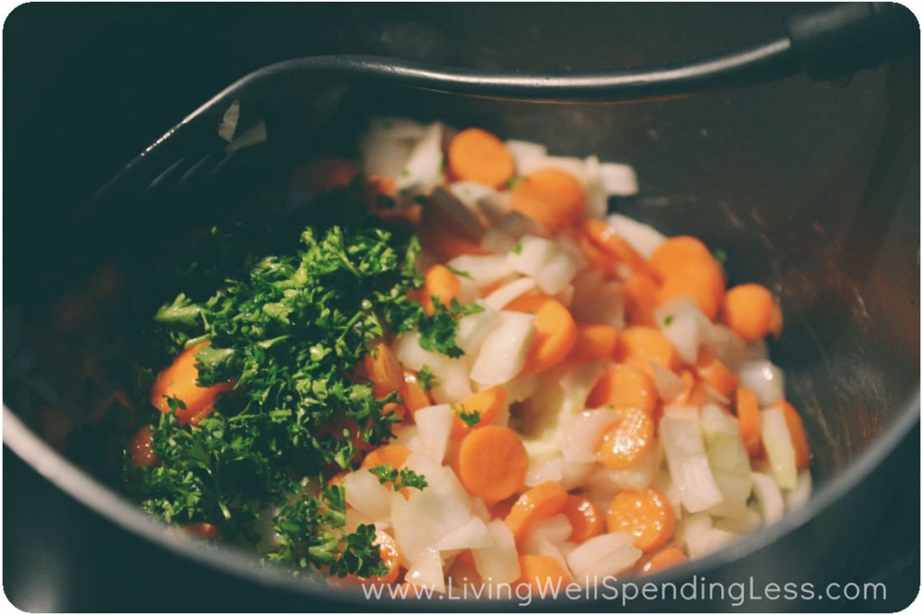 Saute carrots and onions in a pan on the stove. 