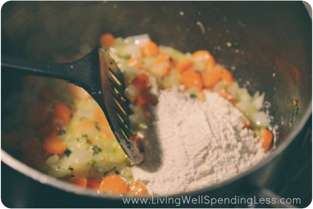 Add flour to vegetable saute.