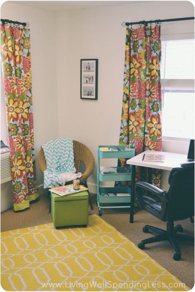 My office got a bright makeover with a yellow rug, yellow and green floral curtains and teal accessories. 