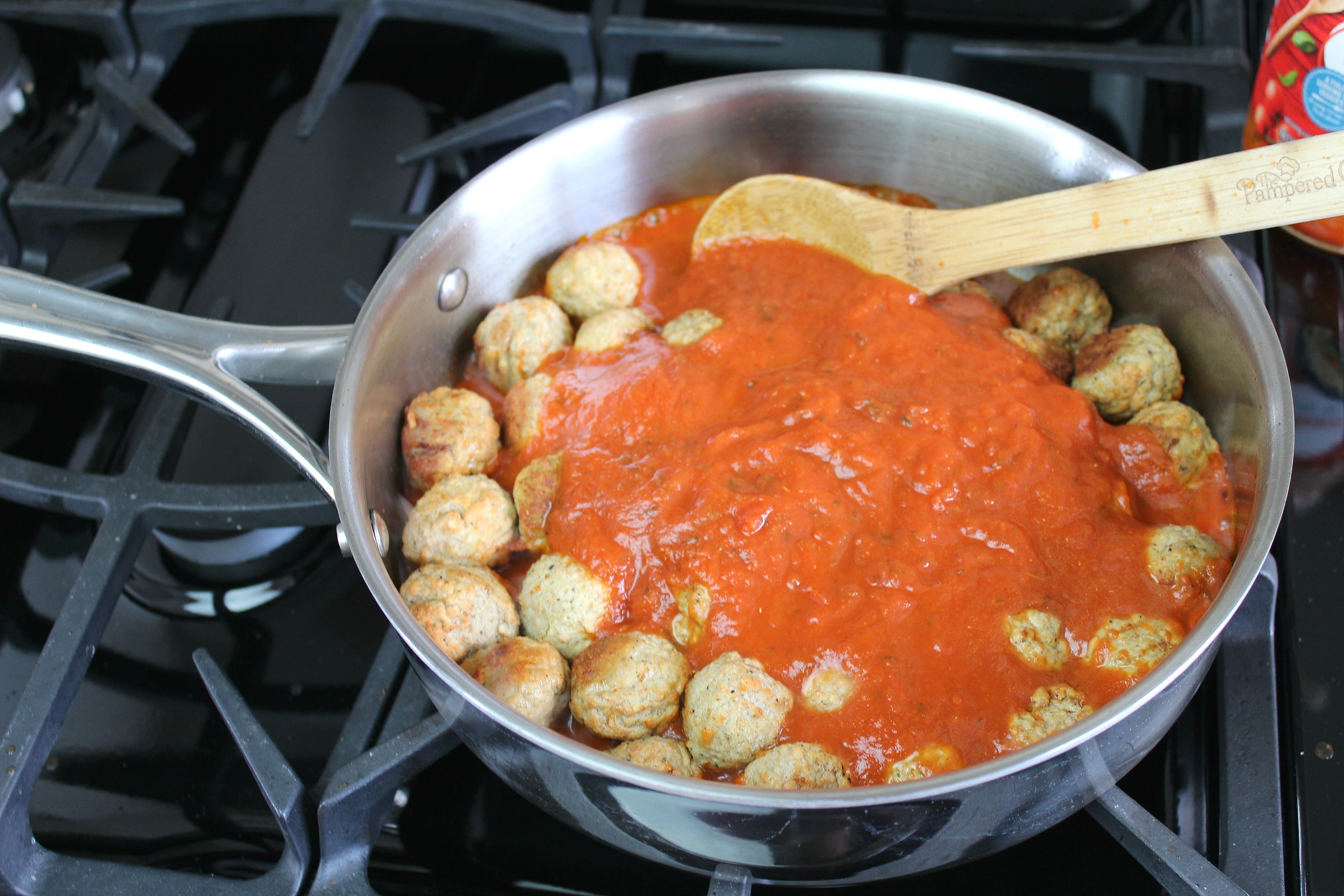 Add tomato sauce to pan over meatballs.