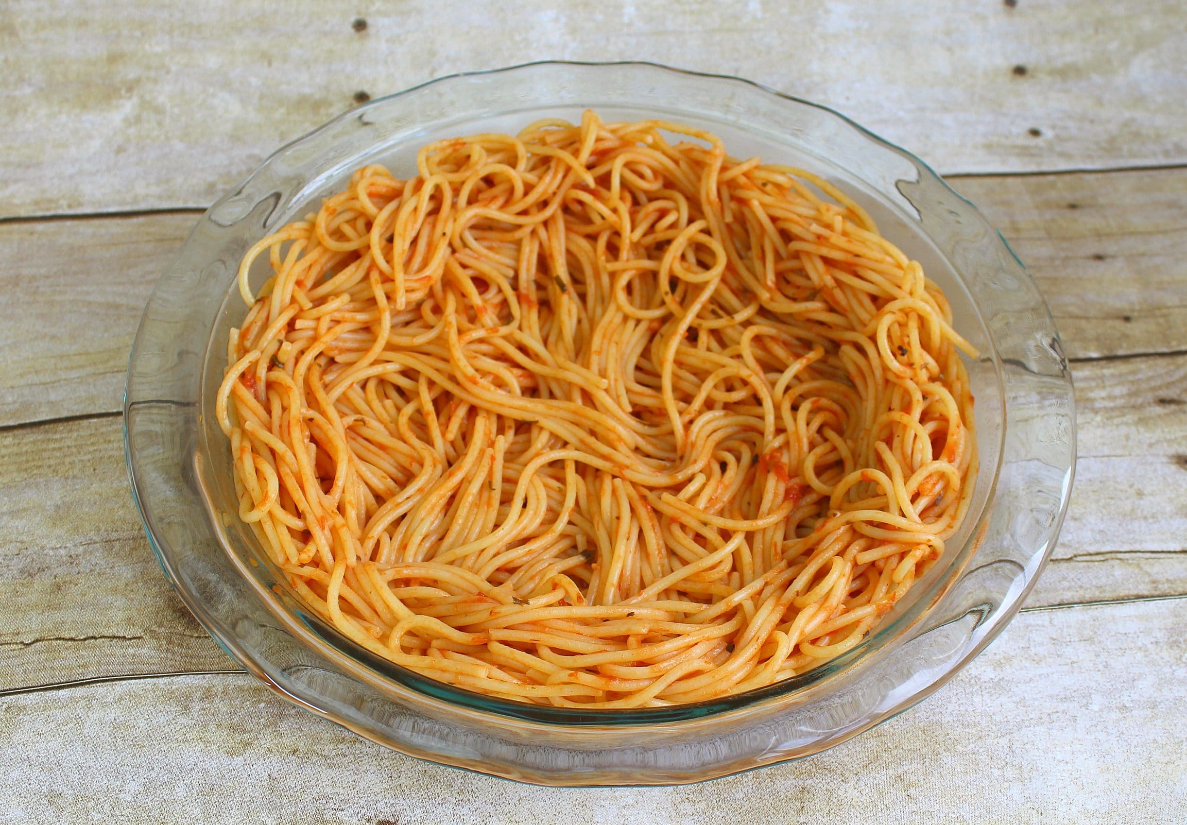 Arrange a nest of pasta inside greased pie plate to form “crust” of pie.