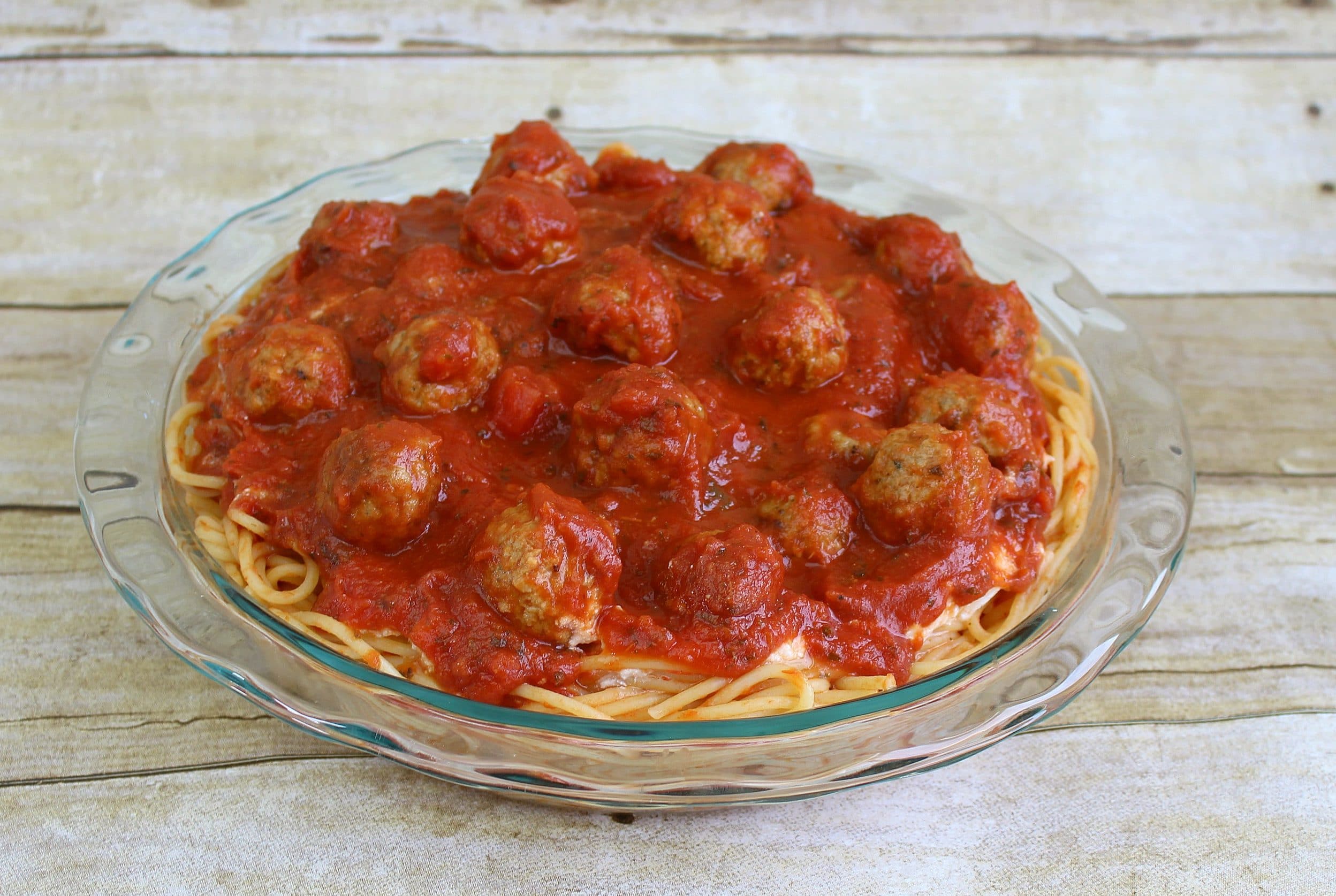 Spread sauce and meatballs over ricotta and pasta "crust." 