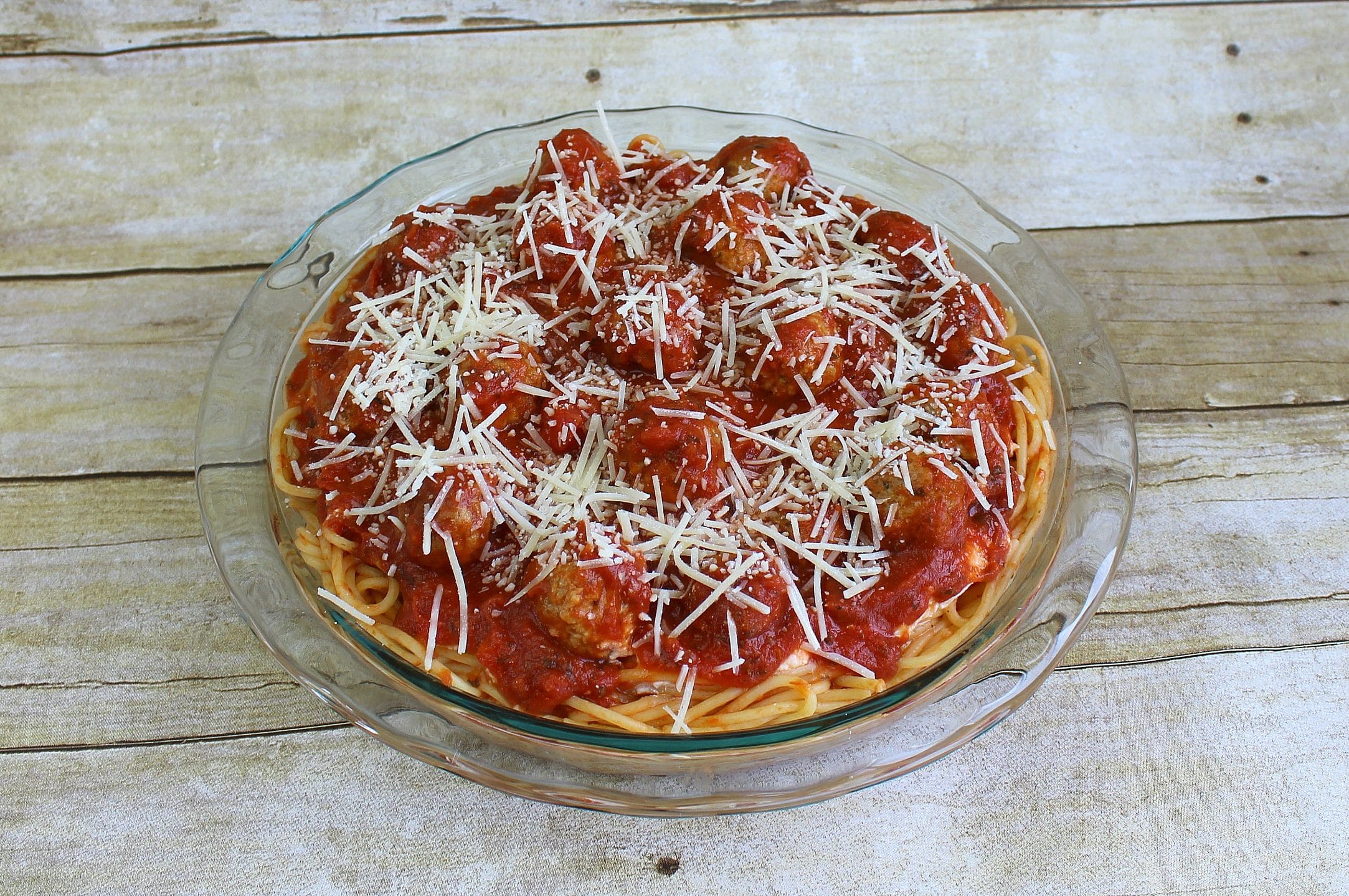 Sprinkle spaghetti pie with some Parmesan cheese. 