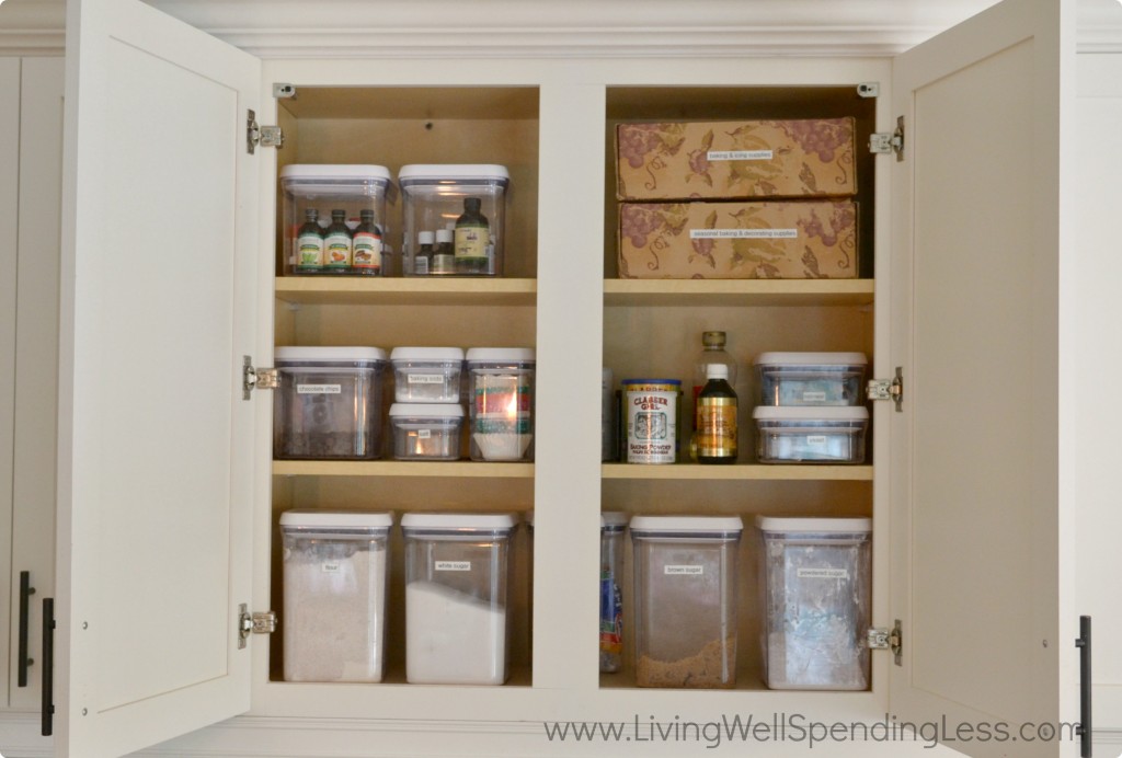 Organized kitchen cabinets with containers. 