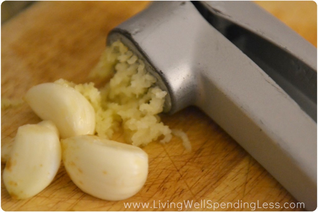 Use a garlic press to finely mince several cloves of garlic. 