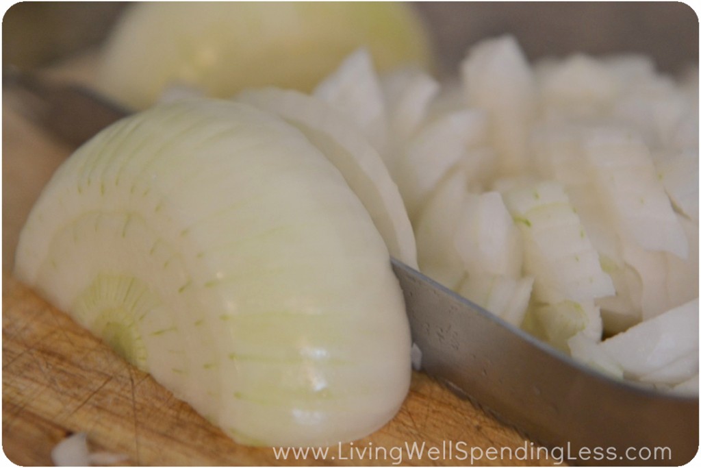 Chop onions on cutting board. 