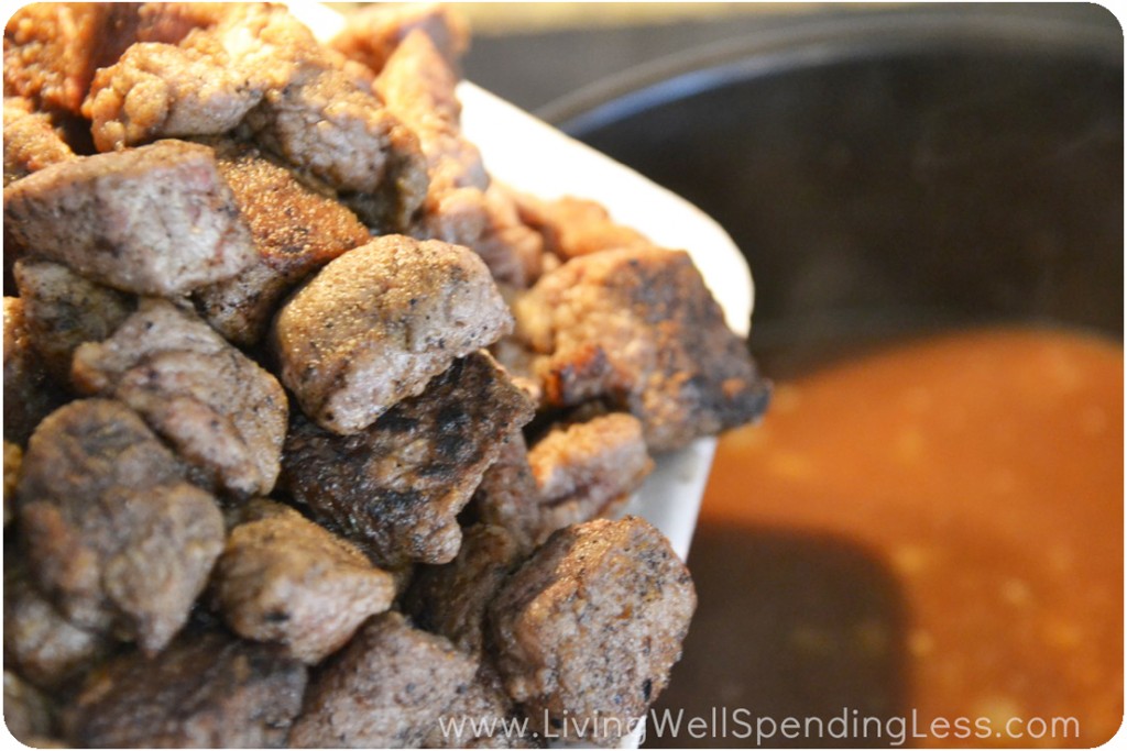 Add seared beef chunks to sauce in dutch oven. 