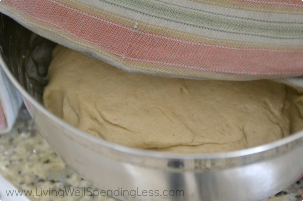 Let the bread dough rise in a butter-coated bowl under a warm, damp towel for 45 minutes to an hour. 