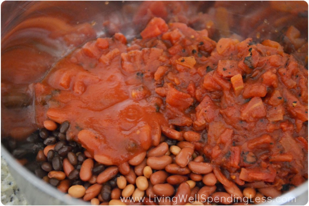 Add the tomato sauce and crushed tomatoes to the beans for your taco soup. 
