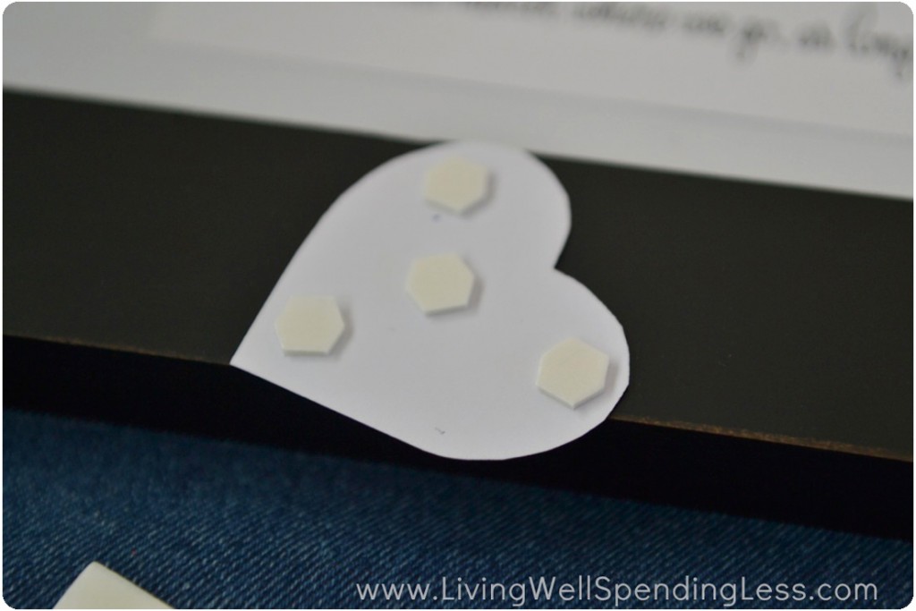Use glue dots to mount the paper hearts on your background. 