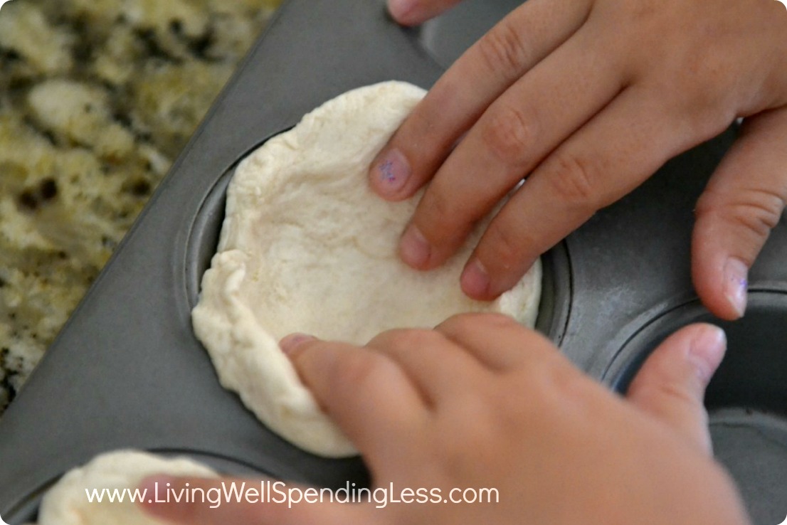 Unroll biscuits and place in muffin tin