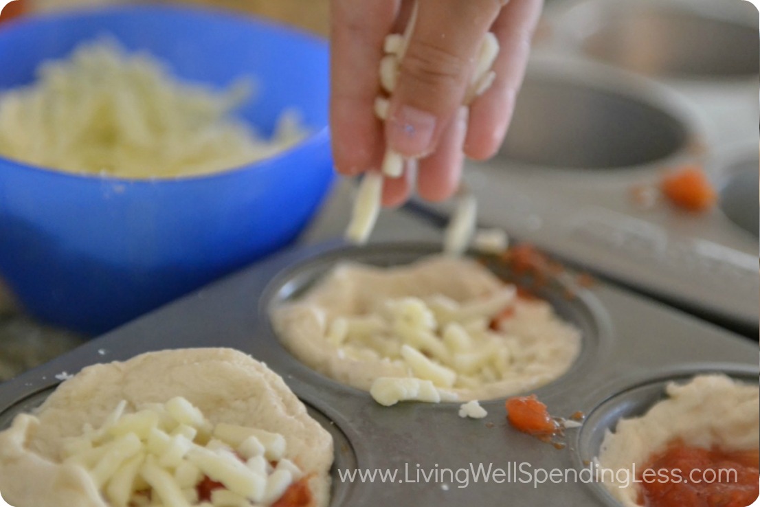 Cover mini pizzas with shredded mozzarella cheese