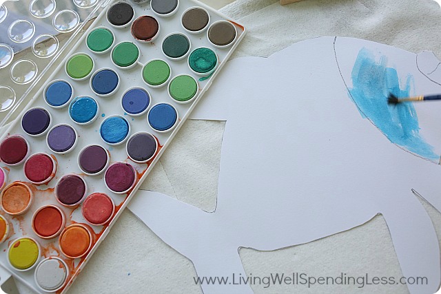 Using your paintbrush, begin painting the fish using blue colors. 