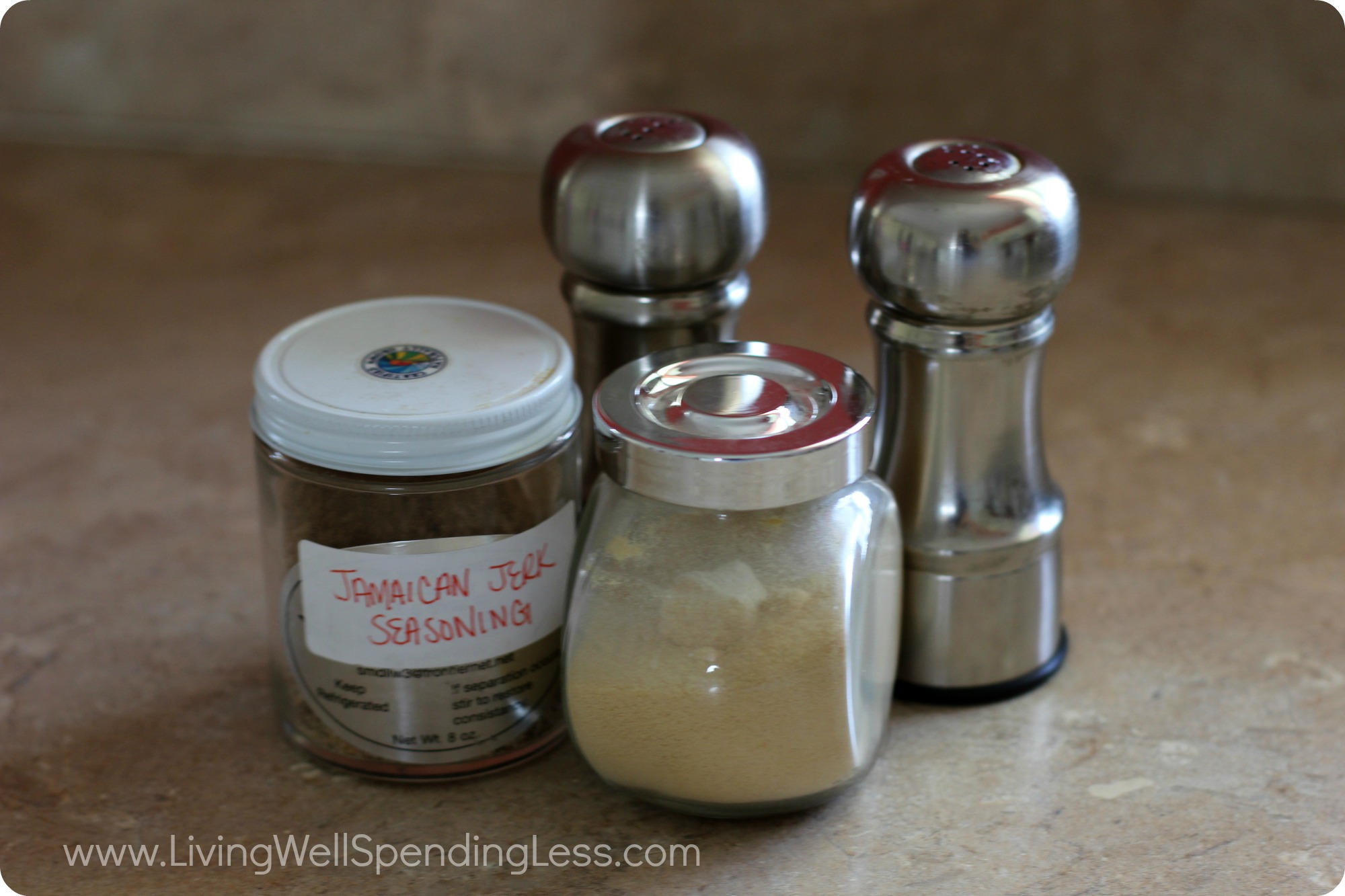 Different seasonings on a kitchen counter top. 