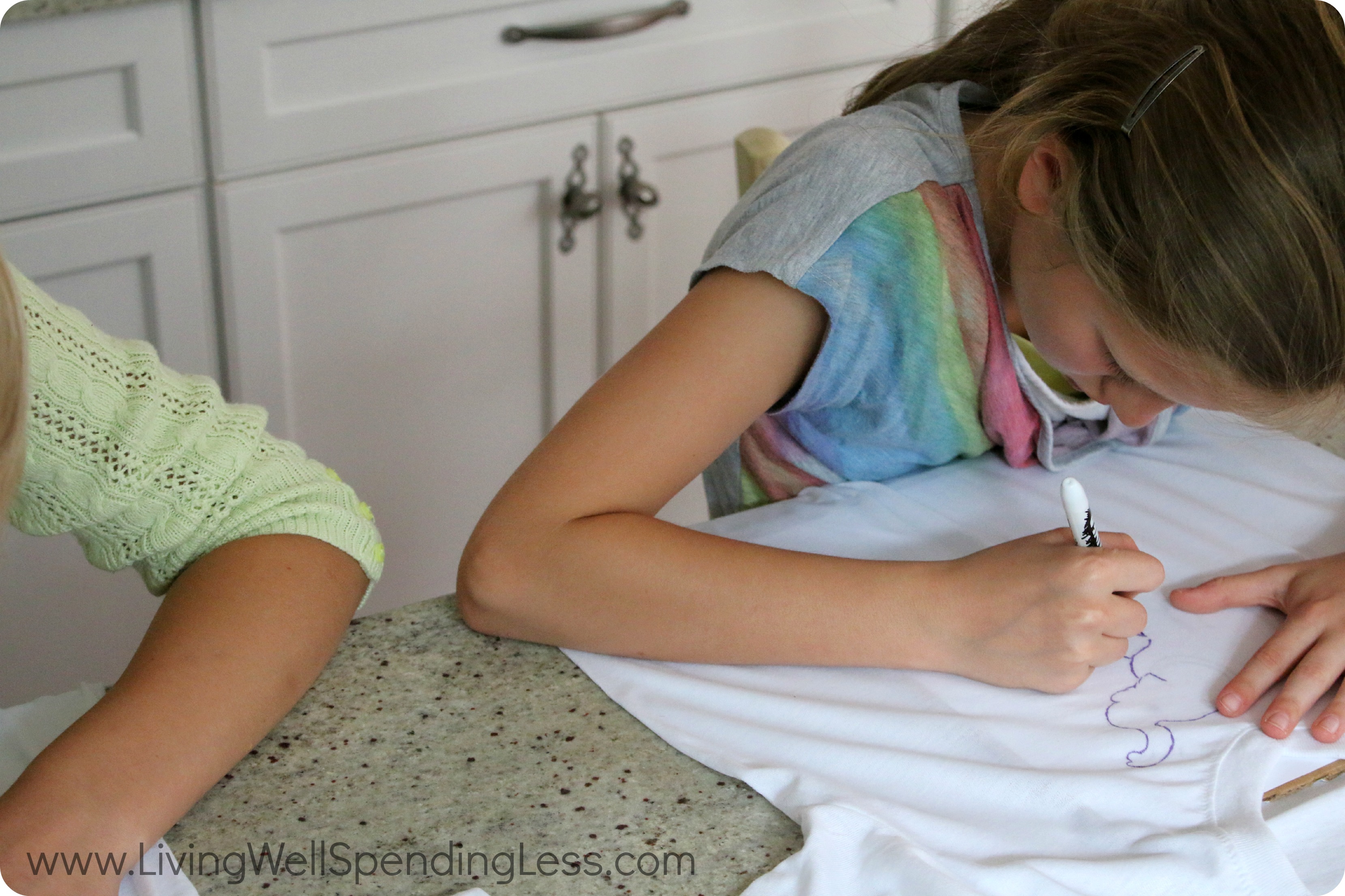 Place the template under the t-shirt and trace the design using the Sharpie markers.