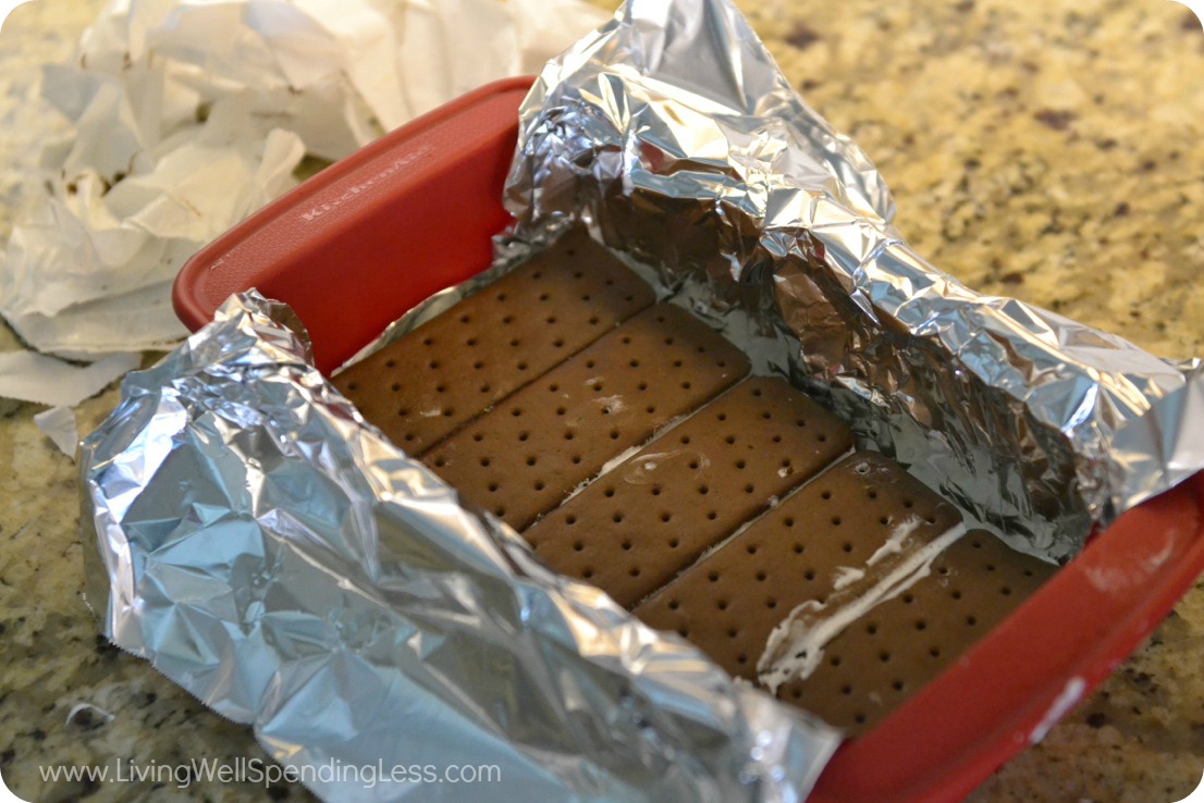 Fit five ice cream sandwiches across the bottom to form the base of your cake. 