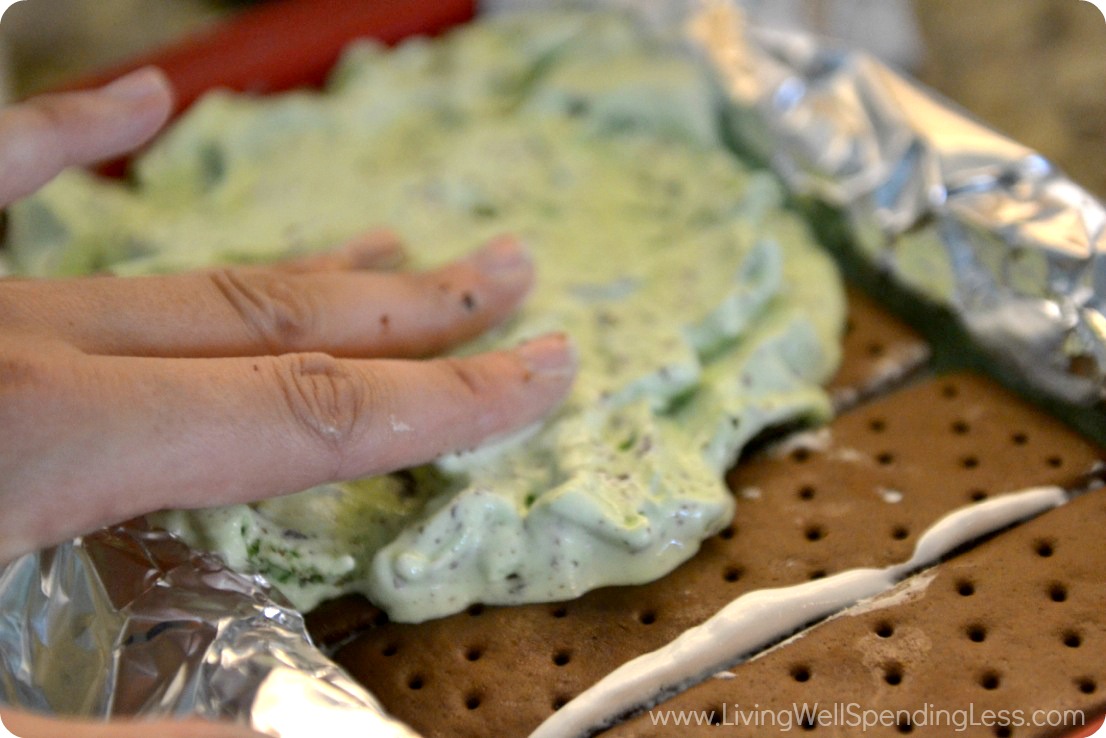Use your fingers or a spatula to spread melted ice cream over the top of the sandwiches. 