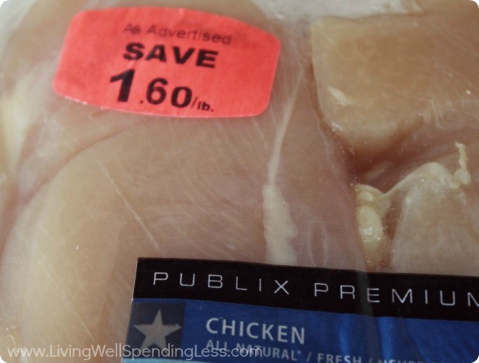 Packaged chicken with a coupon sticker on it. 