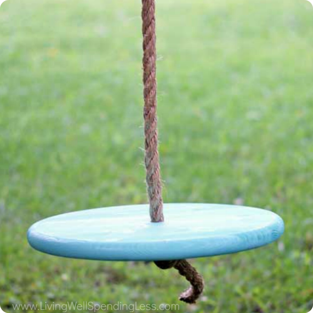 Thread the wooden swing seat onto the bottom of the rope and tie another knot securely under the seat. 