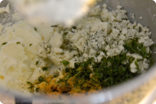 Add blue cheese crumbles, minced garlic, pepper, salt and fresh basil into mixer. 