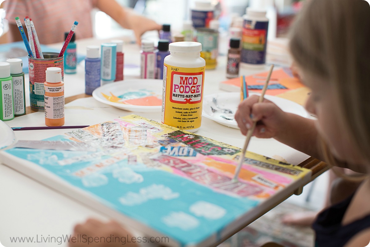 Use paint brush to apply Mod Podge to the entire surface of the painted canvas. 