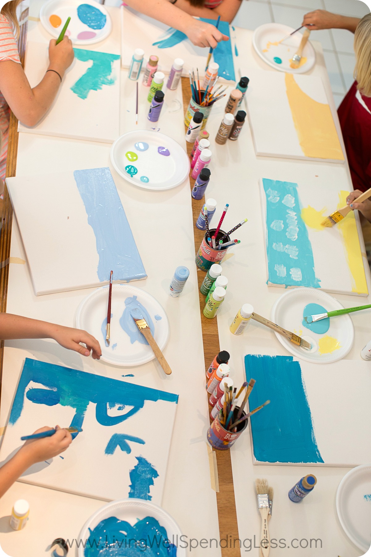 Organize materials onto table and let children begin to paint with acrylic paints. 