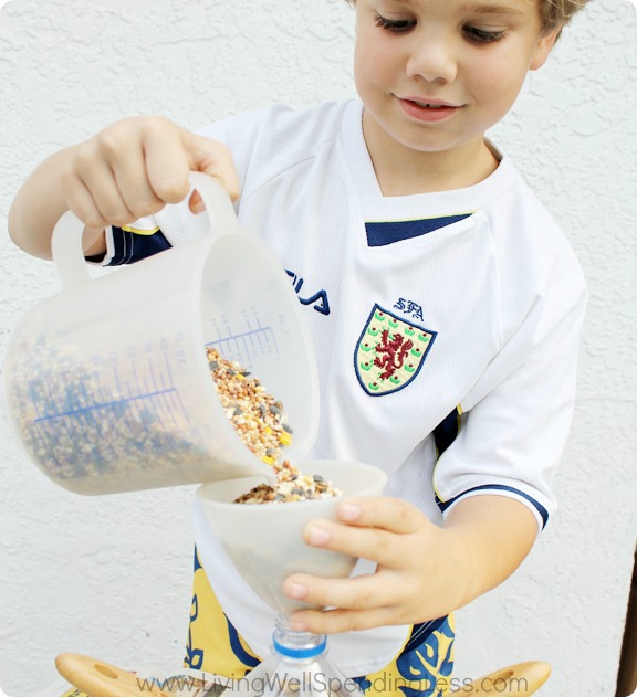 We're getting there! Add birdseed to your easy DIY Bird Feeder.