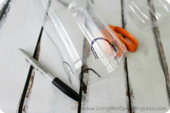 Step 3 of the easy DIY Bird Feeder is to make arches in the water bottle. 